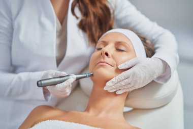 Woman in a beauty salon having needle mesotherapy treatment. High quality photo