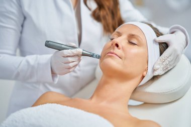 Woman in a beauty salon having needle mesotherapy treatment. High quality photo