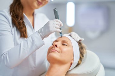 Woman in a beauty salon having needle mesotherapy treatment. High quality photo