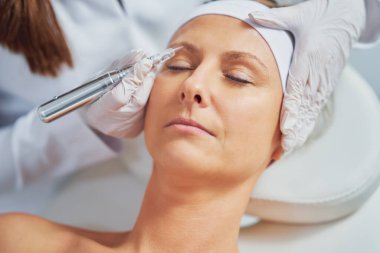 Woman having permanent eyebrows cosmetology treatment. High quality photo