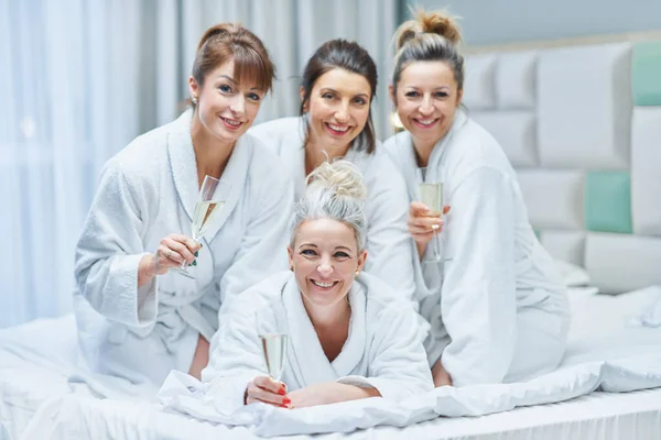 Girls with wine at spa party in the hotel. High quality photo