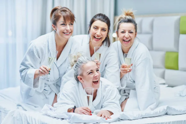 Girls with wine at spa party in the hotel. High quality photo