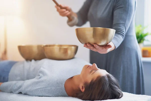 Woman having a Tibetan sound bowl massage. High quality photo