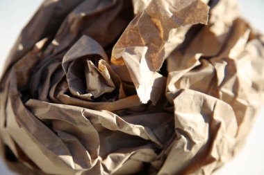 Paper. Rolled Up Brown Paper. Crumpled brown paper bag. Shipping and Packing Paper. close up. crumpled brown ball. Recycling