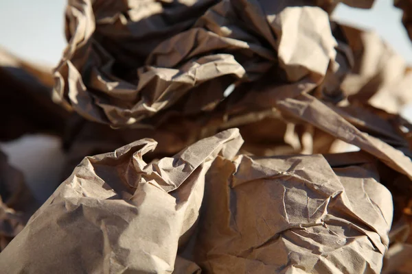Paper. Rolled Up Brown Paper. Crumpled brown paper bag. Shipping and Packing Paper. close up. crumpled brown ball. Recycling