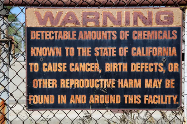 Warning sign. A metal sign warning about detectable amounts of Chemicals that can cause harm or even Death. Metal Warning Sign. Caution sign