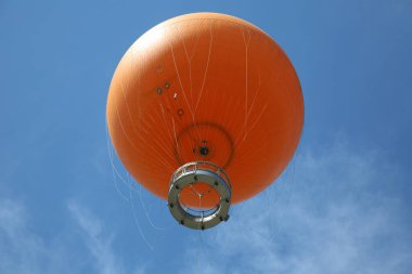 Irvine, California - USA - June 2, 2022: The Orange Balloon in the Great Park in Irvine, California. A beautiful free ride in the Orange Balloon reaching up 400 feet into the sky.   