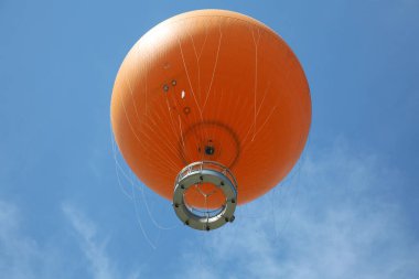 Irvine, California - USA - June 2, 2022: The Orange Balloon in the Great Park in Irvine, California. A beautiful free ride in the Orange Balloon reaching up 400 feet into the sky.   
