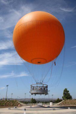 Irvine, California - USA - June 2, 2022: The Orange Balloon in the Great Park in Irvine, California. A beautiful free ride in the Orange Balloon reaching up 400 feet into the sky.   