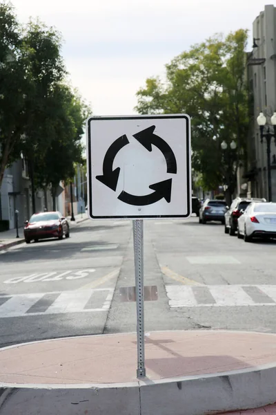 Round About Sign. A traffic Round About sign in the middle of a street. Traffic Sign. USA Traffic Sign.