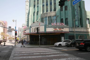 LOS ANGELES, CA -May 12, 20 View of the Pellissier Building and Wiltern Theatre center, a landmark Art Deco building at the corner of Wilshire Boulevard and Western Avenue in Los Angeles, California. clipart