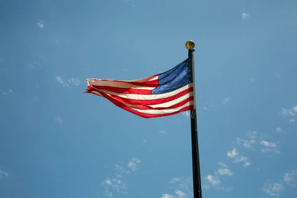 stock image American Flag. American Flag Waving in the breeze for Memorial Day. US Flag for the 4th of July holiday. American flag fluttering in the breeze with a Blue Sky background. USA. Stars and Stripes.