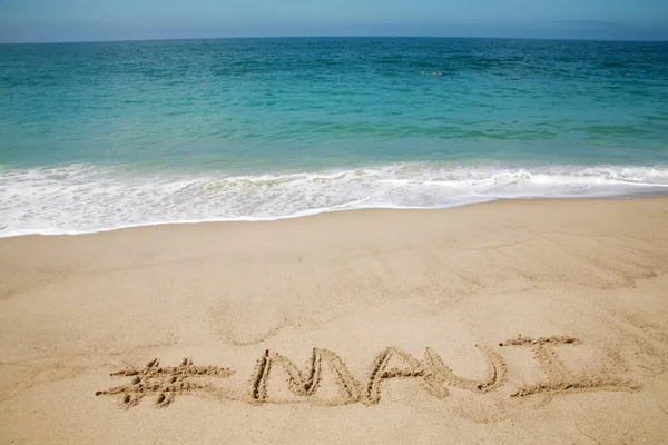 Nazwa Maui Napisana Piasku Plaży Tłem Oceanu Spokojnego — Zdjęcie stockowe