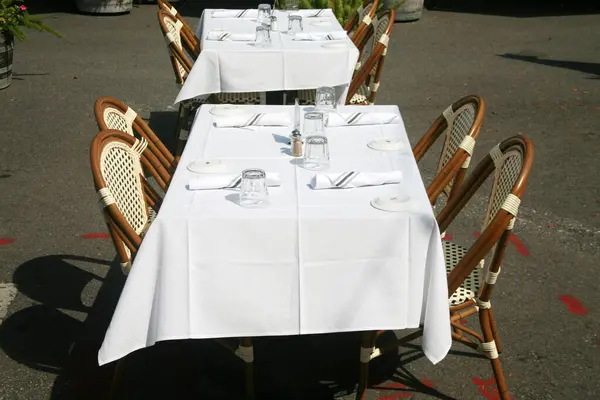 Restaurant. Outdoor Dining at a Restaurant. Table with Chairs. Outdoor Cafe. Outside Dining. Business Lunch. Lunch Date. Dinner Date. Business Dinner. Open Air Restaurant. Outdoor Service. Lunch Time