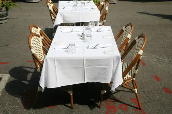 Restaurant. Outdoor Dining at a Restaurant. Table with Chairs. Outdoor Cafe. Outside Dining. Business Lunch. Lunch Date. Dinner Date. Business Dinner. Open Air Restaurant. Outdoor Service. Lunch Time