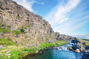 Dağ deresi, İzlanda 'da yazın yüksek kayalıklara ve büyük kayalara çıkardı.