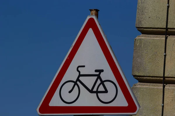 Cycle route ahead warning sign with a blue sky.