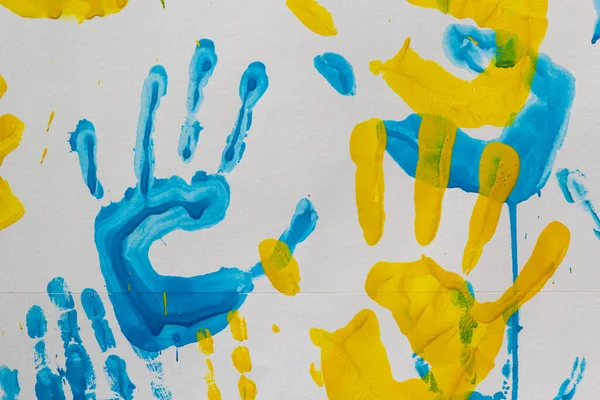 stock image bright prints of children's hands from paint on the wall, background, texture, horizontal format.