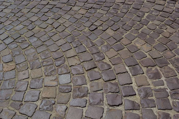 Cobblestone road. Gray cobblestone texture, vintage road surface.