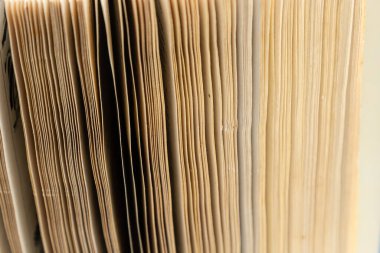 Book background. Stack of books in the library. Old yellow pages of paper books. Learning and knowledge.