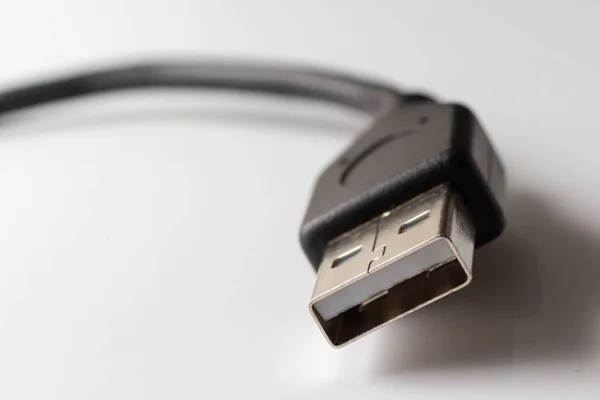 Close up of USB cable on white background. Data transfer technologies between devices via cable.