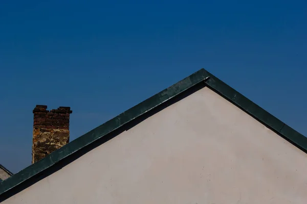 村の家の上に赤レンガの煙突 空を背景に瓦で作られた屋根 — ストック写真