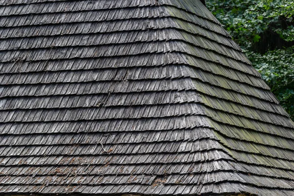Traditional wooden roof tiles in ukrainian Carpathians region. Old roof covered with wooden tiles.
