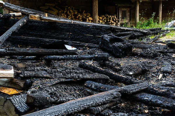 stock image Destroyed by fire wooden house completely burned to the ground .ruins of a burnt wooden house after a fire .