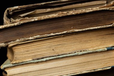 Book background. Stack of books in the library. Old yellow pages of paper books. Learning and knowledge.