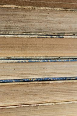 Book background. Stack of books in the library. Old yellow pages of paper books. Learning and knowledge.