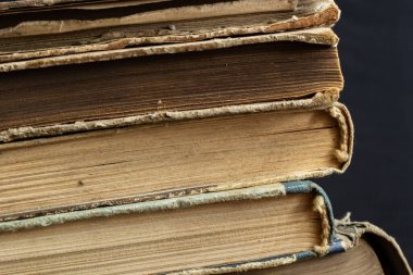 Book background. Stack of books in the library. Old yellow pages of paper books. Learning and knowledge.