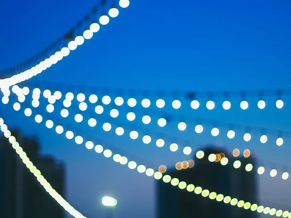 Party lights at outdoor wedding. string lights. defocused bokeh lights in blur. blurred background.