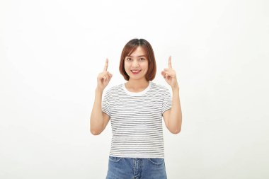 Beyaz bir arka plan fotokopi alanının üzerinde duran kısa boylu esmer, t-shirt ve kot giyen yakışıklı Asyalı genç iş kadını.