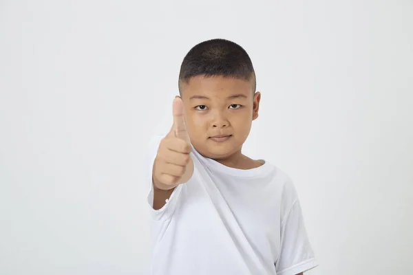 stock image Cute smiling Asian boy in a plain white t-shirt looking at the camera in an isolated studio light white color background