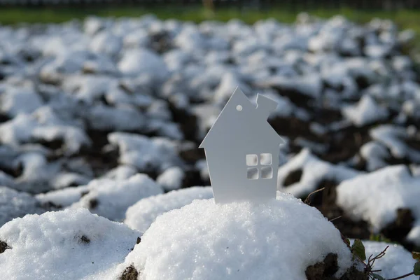 House in winter field. Eco house concept