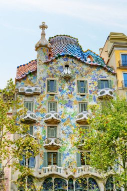 Barcelona, Spain - August 21, 2014: Colorful view of Casa Batllo. The amazing building is designed by Antoni Gaudi. Casa Batllo is part of a UNESCO World Heritage Site. clipart