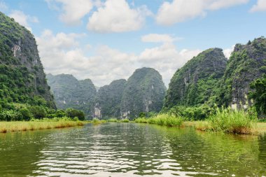Ninh Binh Eyaleti, Vietnam 'daki Tam Coc bölgesindeki Ngo Dong Nehri ve doğal karst kulelerinin muhteşem manzarası. Muhteşem bir manzara. Tam Coc Asya 'da popüler bir turistik merkezdir..