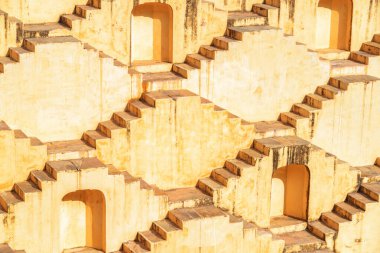 Amazing view of steps and niches of Panna Meena ka Kund reservoir in Amer town, Rajasthan, Jaipur, India. The ancient step well is a popular tourist attraction of South Asia. clipart