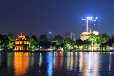 Hoan Kiem Gölü 'nün (Geri Dönen Kılıç Gölü) ve Vietnam' da Hanoi 'nin tarihi merkezinde bulunan Kaplumbağa Kulesi' nin muhteşem gece manzarası. Şehir ışıkları göle yansıyor..