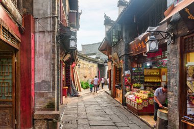 Fenghuang, Çin - 23 Eylül 2017: Phoenix Antik Kenti 'nin (Fenghuang İlçesi) sıcacık dar sokağının muhteşem manzarası. İnanılmaz otantik evler. Fenghuang, Asya 'nın popüler bir turizm merkezidir..