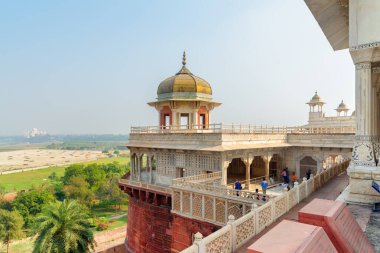 Agra, Hindistan - 9 Kasım 2018: Musamman Burj 'un güzel manzarası, Agra Kalesi. Tac Mahal arka planda görünüyor. Kubbeli sekizgen kule Güney Asya 'nın popüler bir turistik merkezidir..