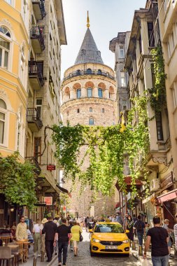İstanbul, Türkiye - 15 Eylül 2021: Eski dar bir sokaktan Galata Kulesi 'nin manzarası. İstanbul dünyada popüler bir turizm beldesi.