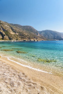 Türkiye 'nin Oludeniz Sahili' nden Akdeniz 'in harika berrak sularının manzarası. Manzaralı dağlar arka planda görünür. Oludeniz, Türkiye 'de popüler bir turizm merkezi..