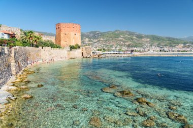 Awesome view of the Kizil Kule by the Mediterranean Sea in Alanya, Turkey. The Red Tower is a popular tourist attraction in Turkey. clipart