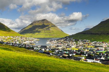 Arka planda fiyort, liman ve muhteşem dağları olan Klaksvik kasabası, Bordoy Adası, Faroe Adaları, Danimarka. Peyzaj fotoğrafçılığı
