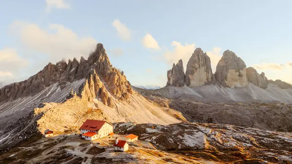 stock image Panoramic view on Tre Cime di Lavaredo and rifugio Locatelli in Dolomite Alps during sunset. Three peaks of Lavaredo, Dolomites, South Tyrol, Italy, Europe. Landscape photography panorama