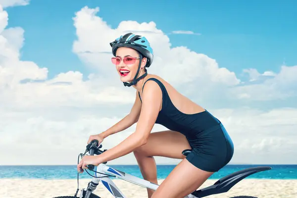 Joyful Young Woman Wearing Swimsuit Rides Bicycle Sandy Beach Capturing Stock Image