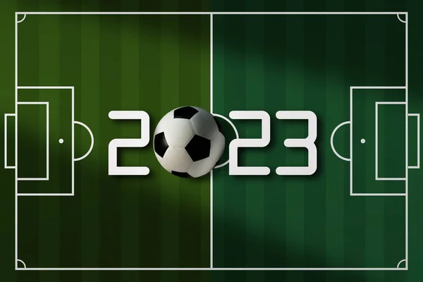 Top view of soccer ball on soccer field with number 2023. Tournament concept.