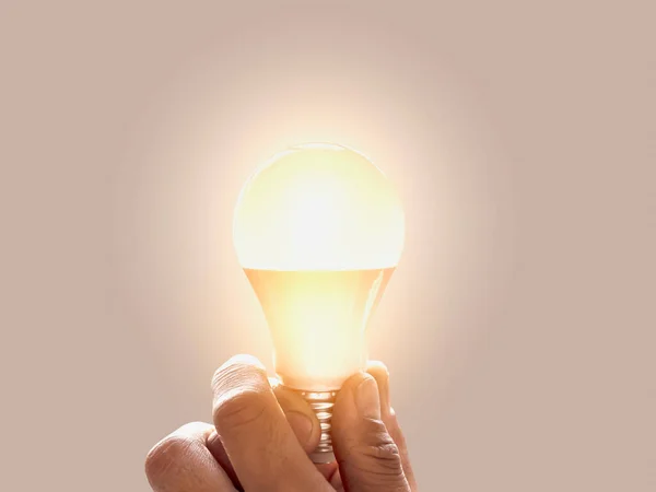 man holding a light bulb creativity, innovation And inspiration. creative concept and inspiration for sustainable business development. copy space background.