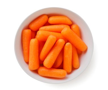 Peeled carrots in a plate close-up on a white background. Top view